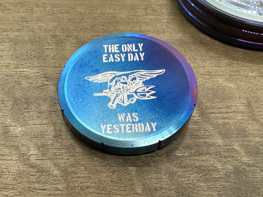 "The only easy day was yesterday.” Flamed Titanium Spinning Worry Coin